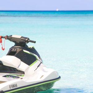 An image of a jet ski parked in turquoise clear waters.