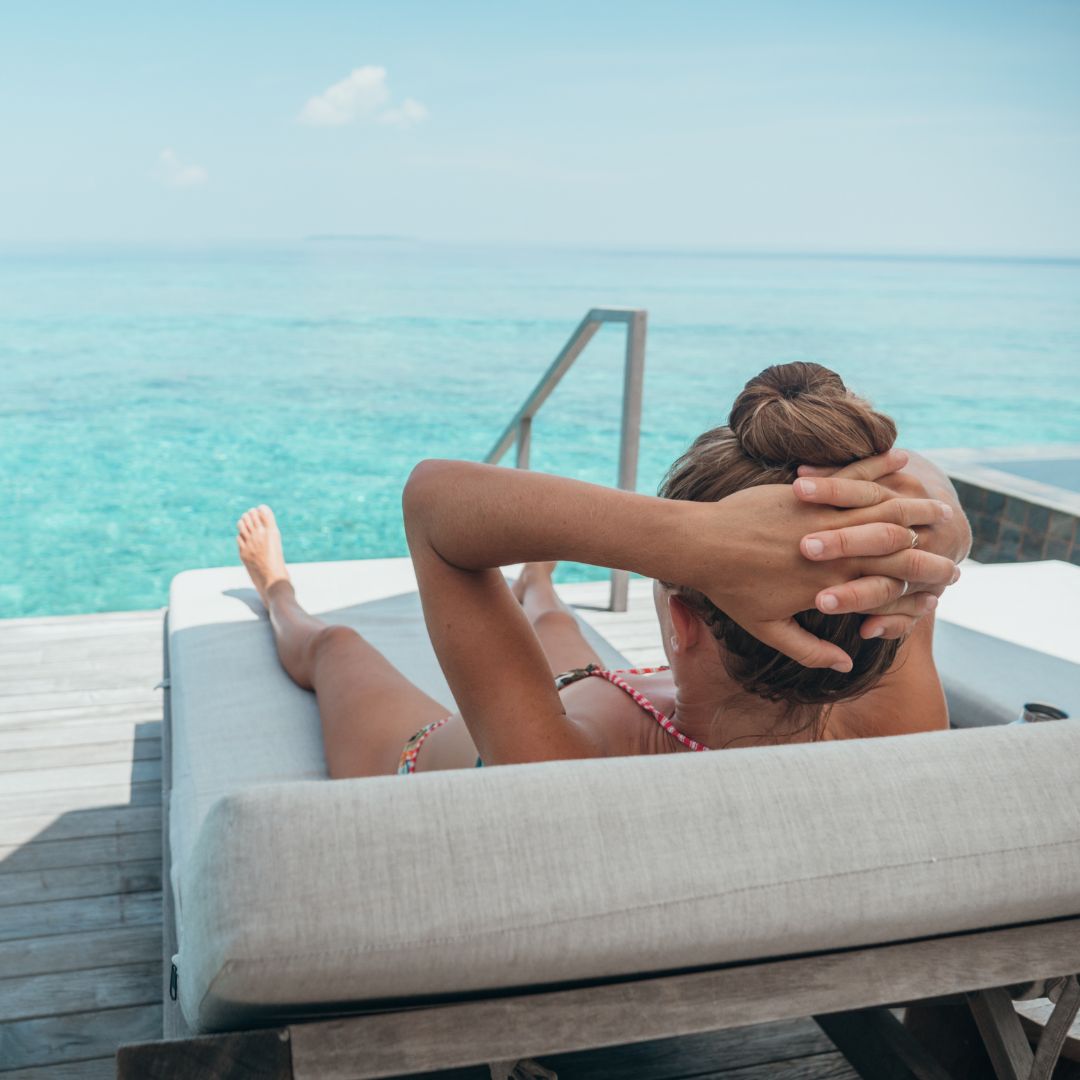 Woman in Lounger by the Water