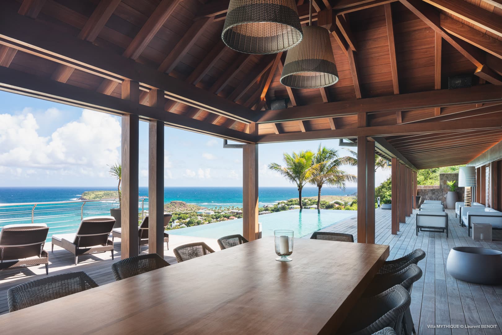 An example of one of our villa rental partners. An image of a pool and patio with the ocean in the background.